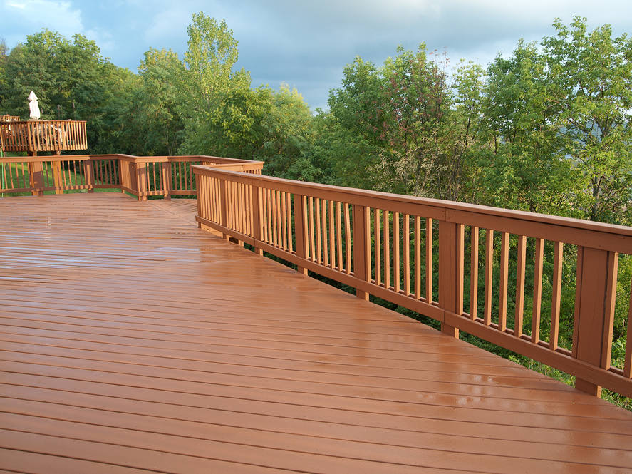 A,Freshly,Painted,And,Stained,Wood,Deck,With,Railing,On