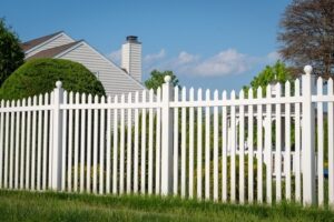 White,Vinyl,Fence,In,A,Cottage,Village,Tall,Thuja,Bushes